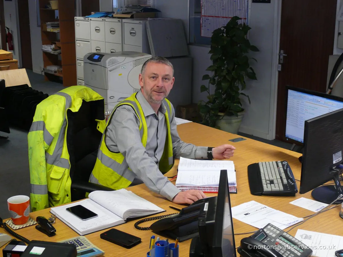 Keith Robinson, Transport Manager at Nortons Hiab Services, at his desk in the Manchester traffic office