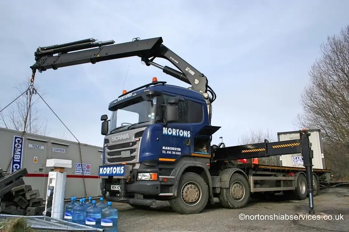 Portable cabin being lifted from a Nortons lorry