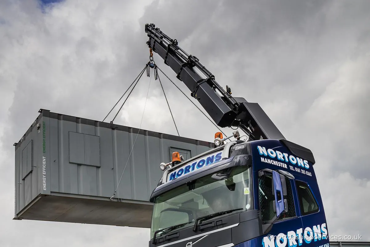 A refurbished cabin lifted off the deck by the crane in the Nortons yard at Miles Platting