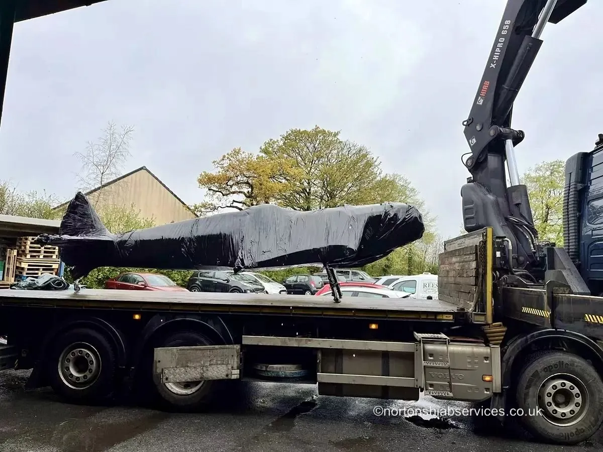 A sheeted and strapped load on a Nortons trailer ready to leave