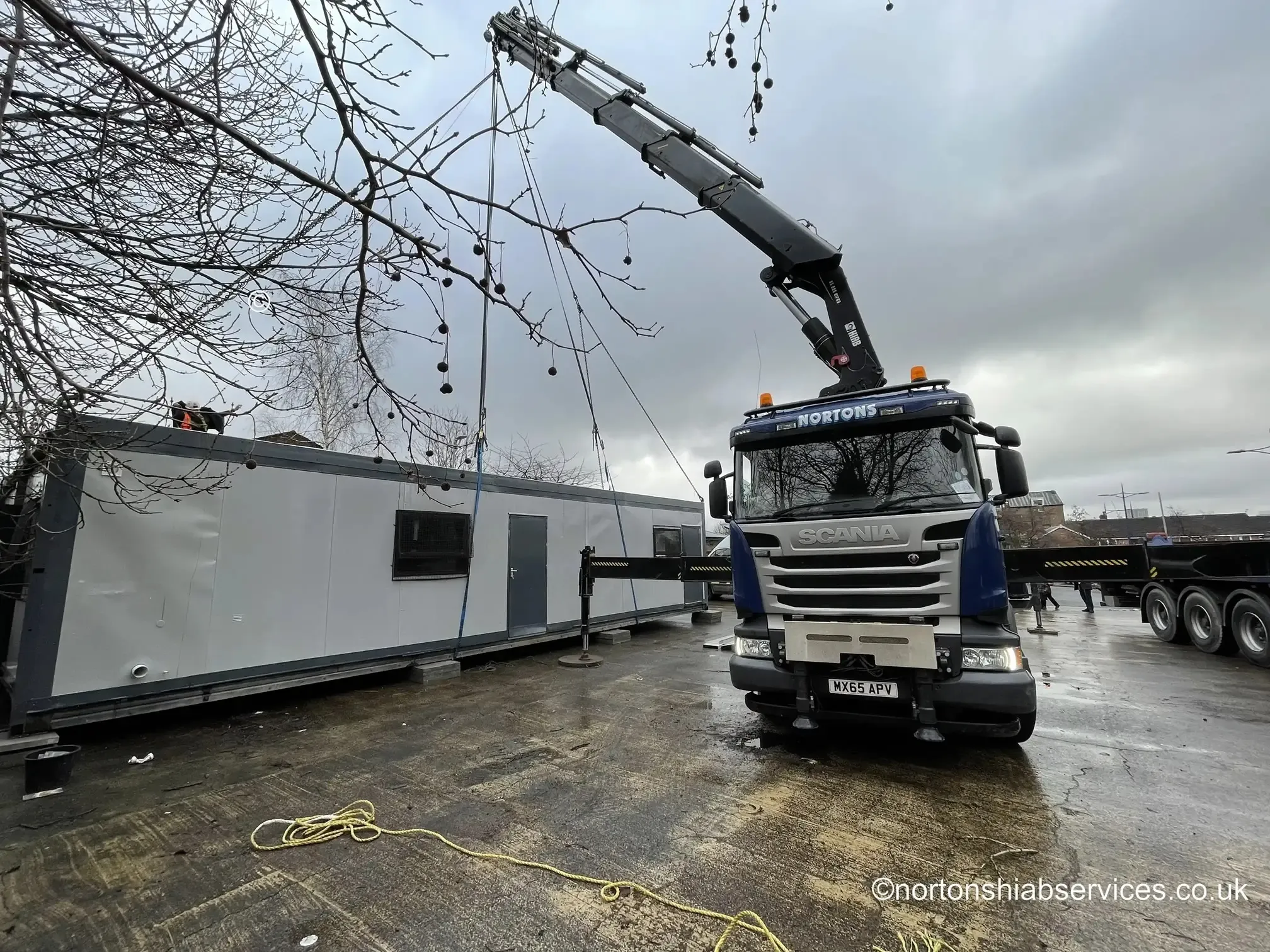 Nortons wagon and drag loaded with a modular building on a Manchester job