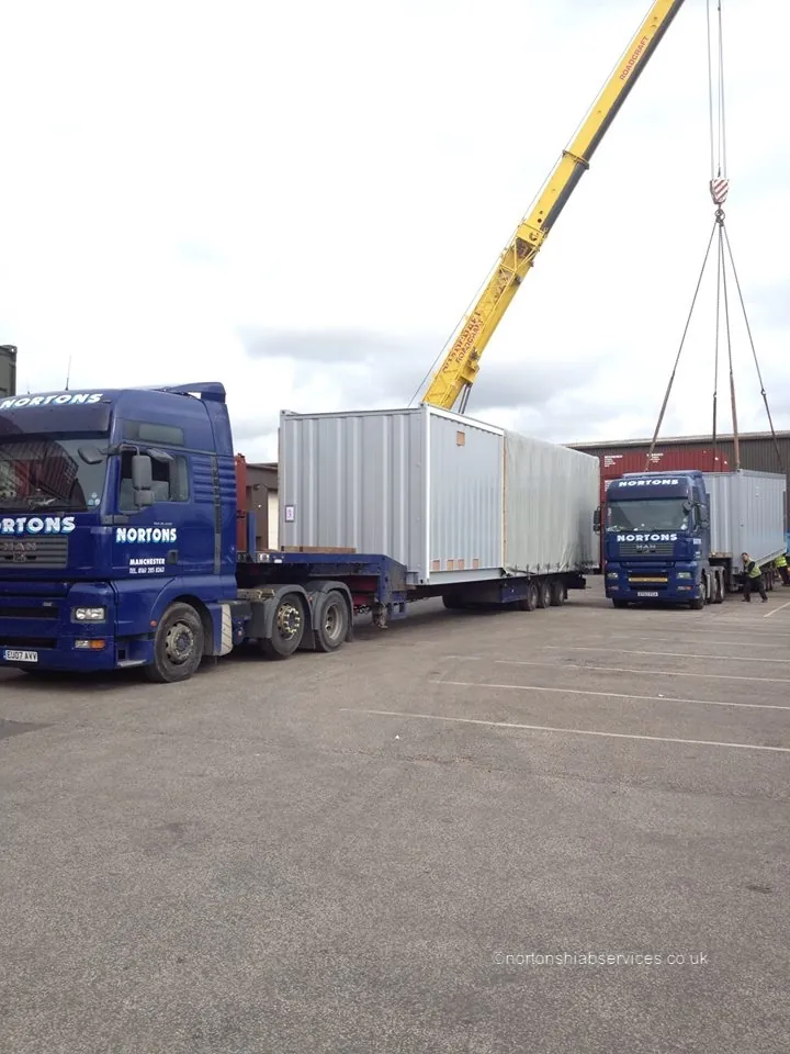Two Nortons hiab lorries working together on a container lift