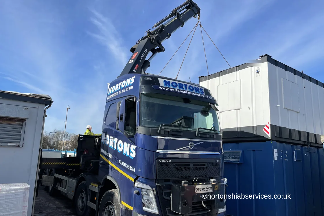 Nortons hiab with the boom extended over a row of stacked units