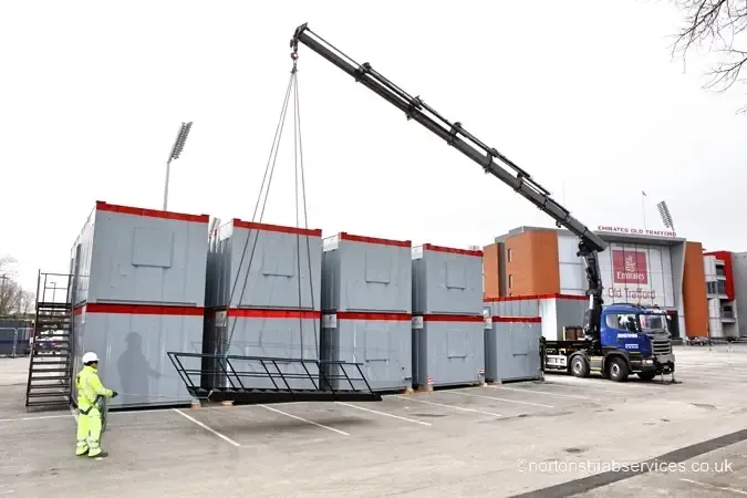 Nortons hiab placing containers at a cricket ground