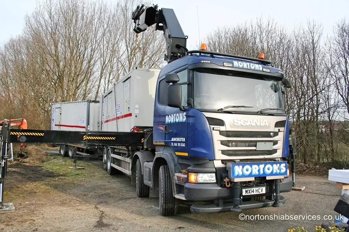 Several shipping containers delivered and positioned by a Nortons hiab