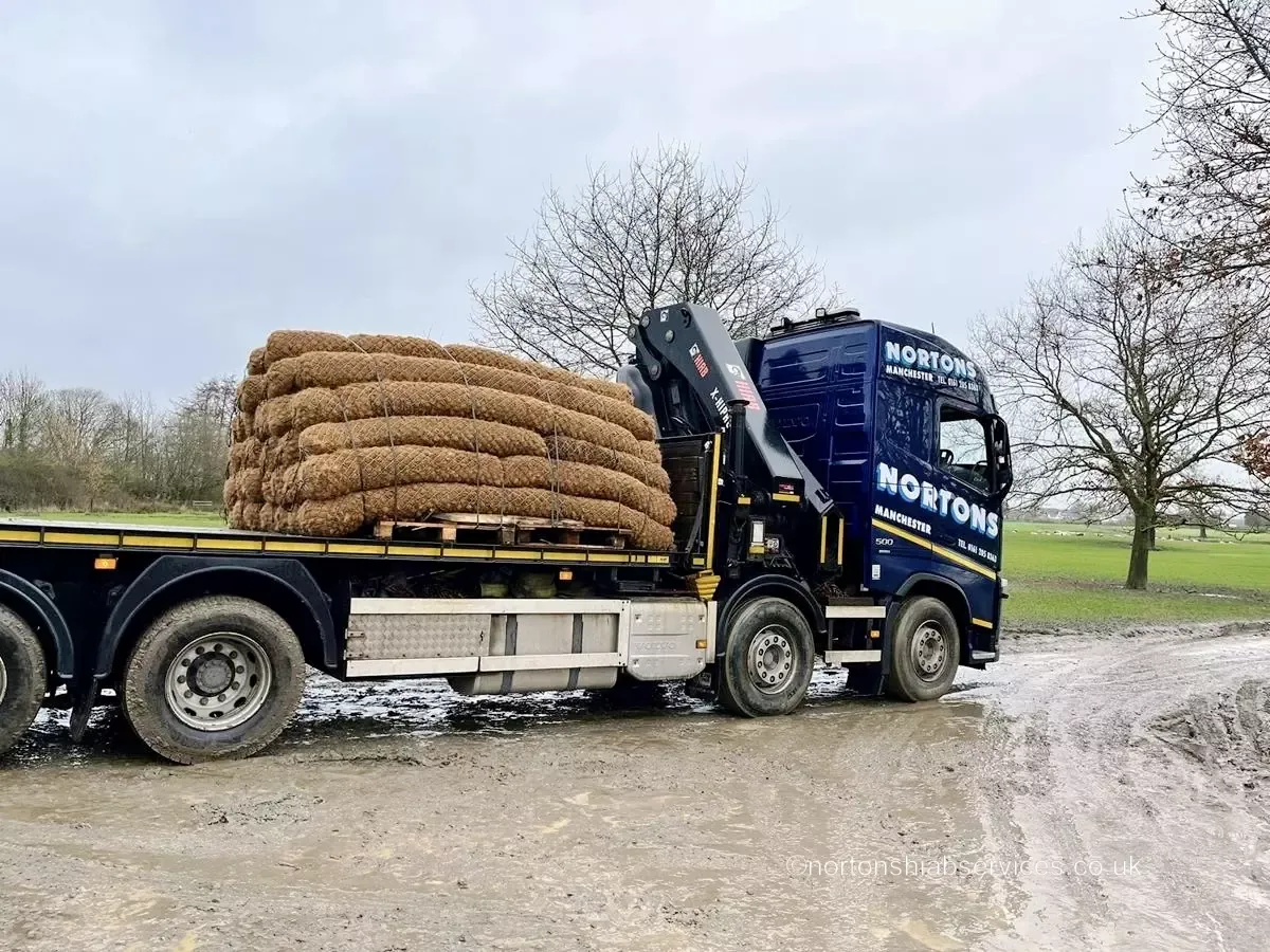 Nortons hiab lorry loaded with rolled matting