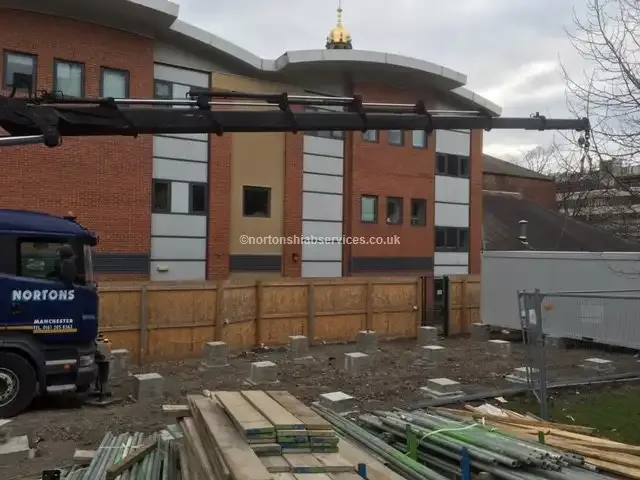 Nortons crane lorry delivering structural steel to a building site