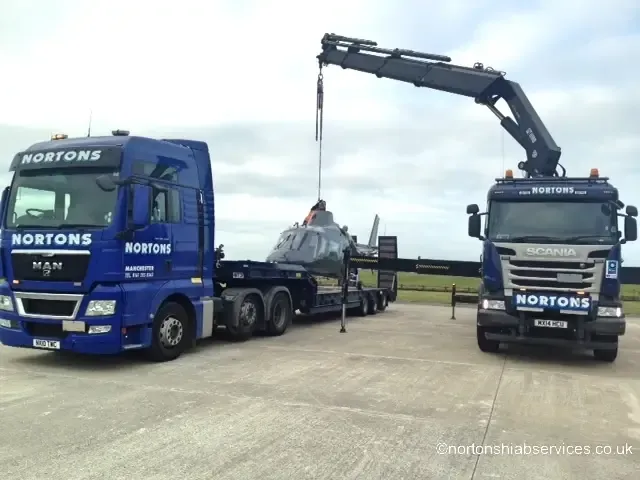 Two Nortons hiab lorries standing together with their cranes stowed