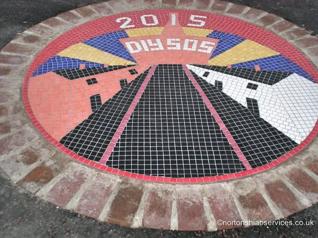 A mosaic roundel set into the road surface marking the 2015 Canada Street build
