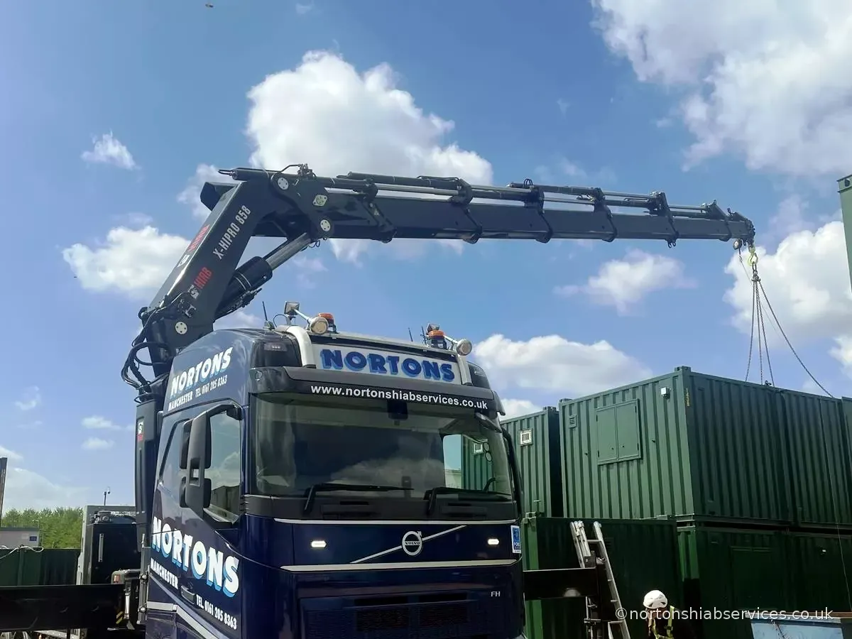 Nortons hiab lifting a site container with the boom extended
