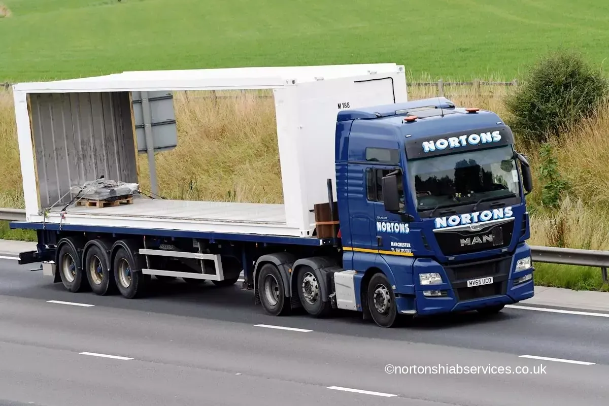 Nortons wagon and drag carrying a large panel on the motorway