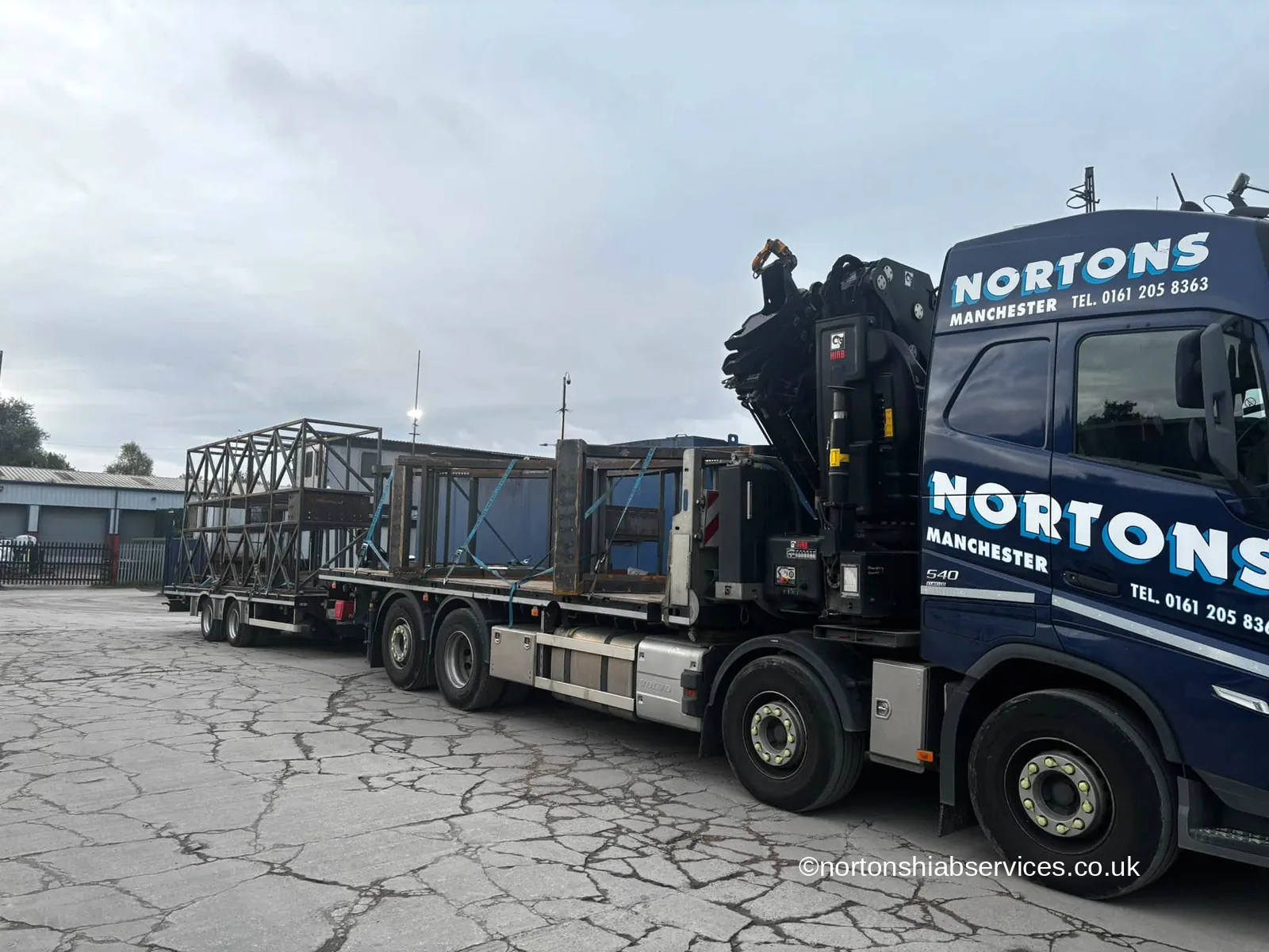 A Nortons eight wheel hiab lorry and drag trailer both loaded with the steelwork of a giant tambourine installation