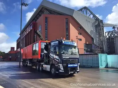 Nortons hiab with a red container on the deck outside the stand at Anfield