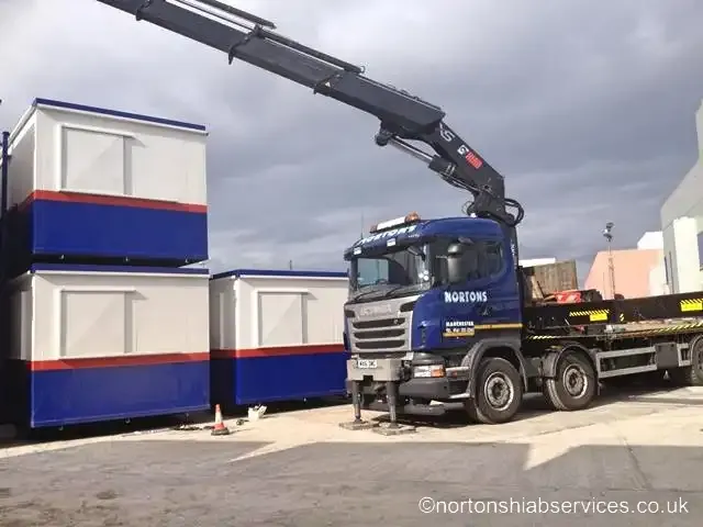 Nortons rigid hiab lorry loaded with stacked portable site cabins