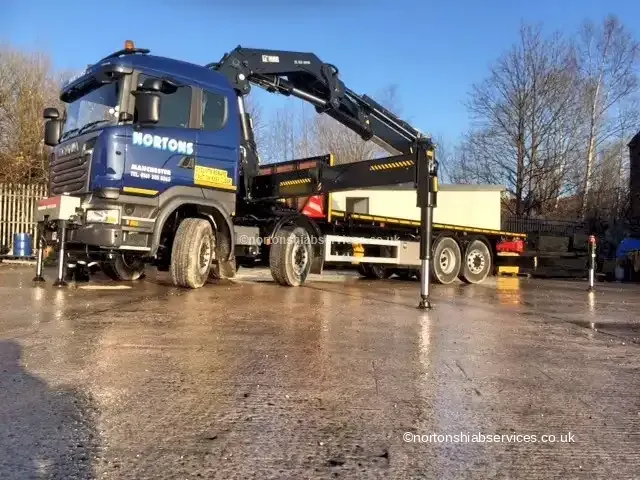 Nortons Scania rigid 858 hiab lorry set up on outriggers on a wet yard