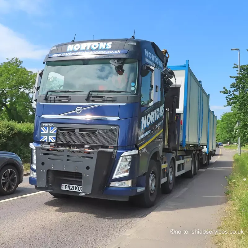 A Nortons lorry loaded with site cabins travelling on the A39 towards Glastonbury