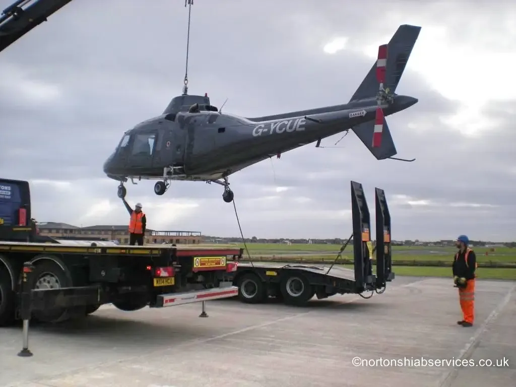 Helicopter airframe suspended clear of the ground on a Nortons truck-mounted crane at Blackpool Airport