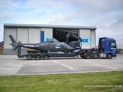 Loaded helicopter on the trailer standing outside the hangar at Blackpool Airport