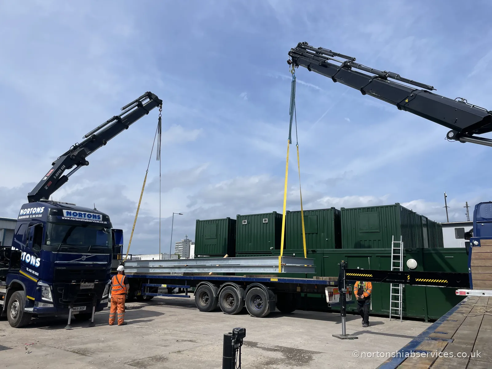 Two Nortons hiabs rigged either side of a long steel section for a dual lift