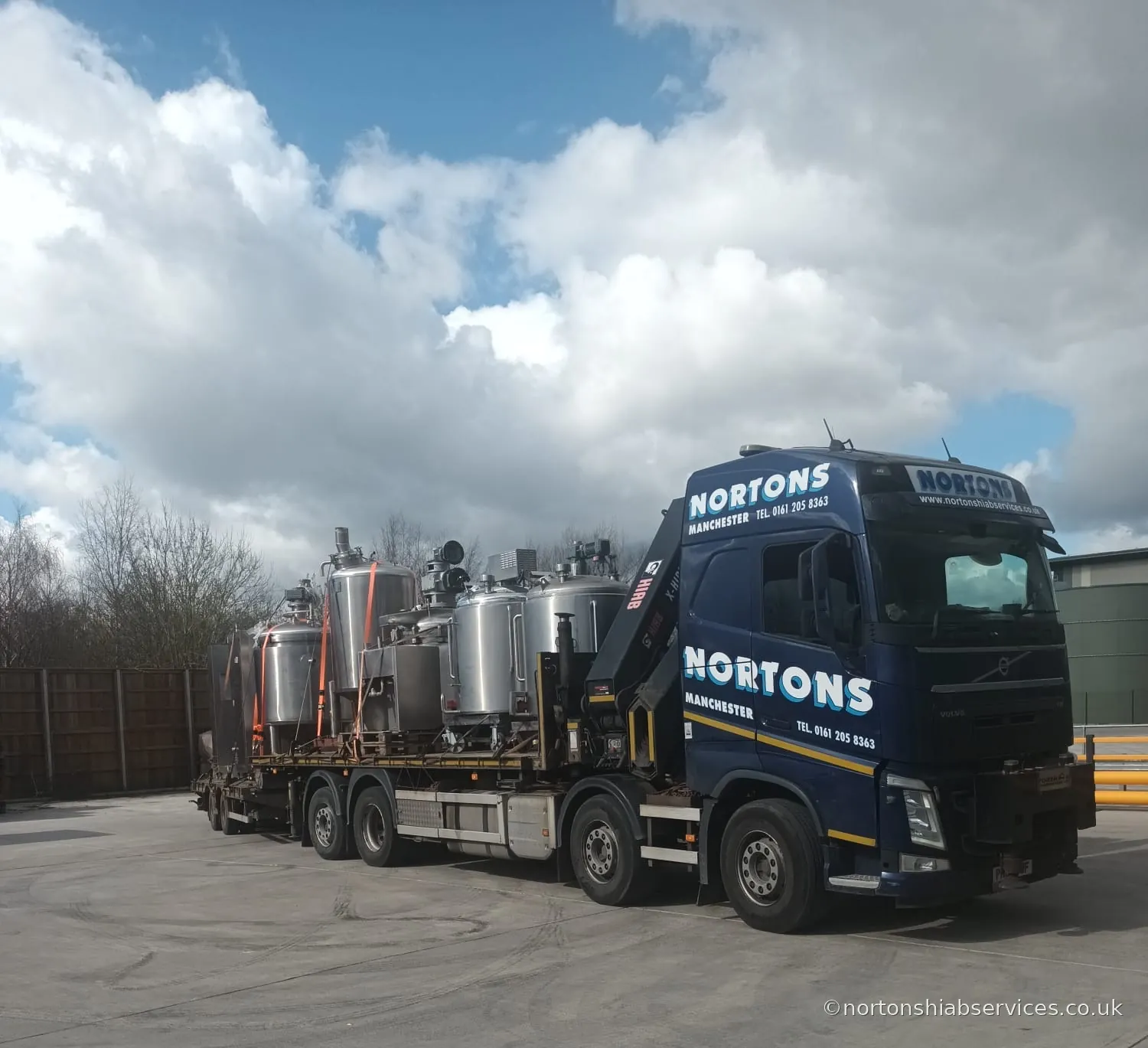 Stainless steel process vessels loaded and strapped down on a Nortons wagon and drag