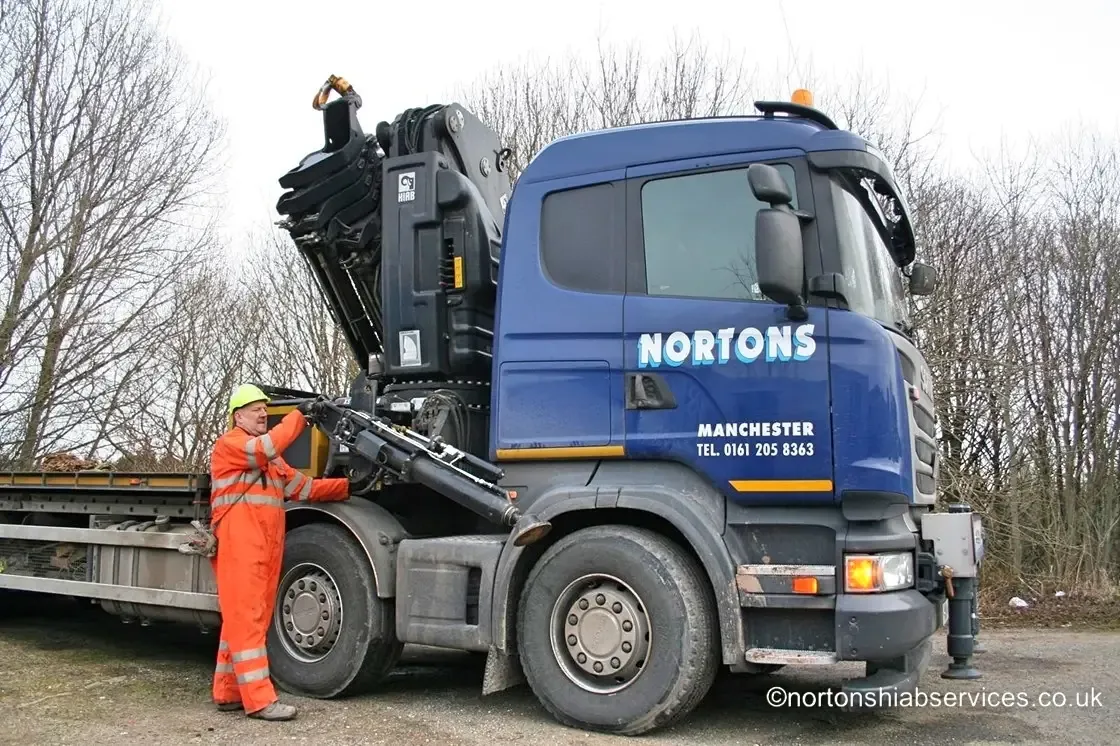 Nortons banksman in high visibility clothing directing a hiab lift on site