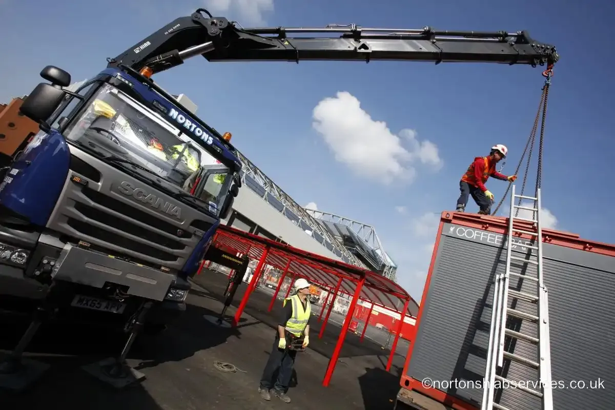 A Nortons operative slinging a unit from a ladder at the Anfield site setup