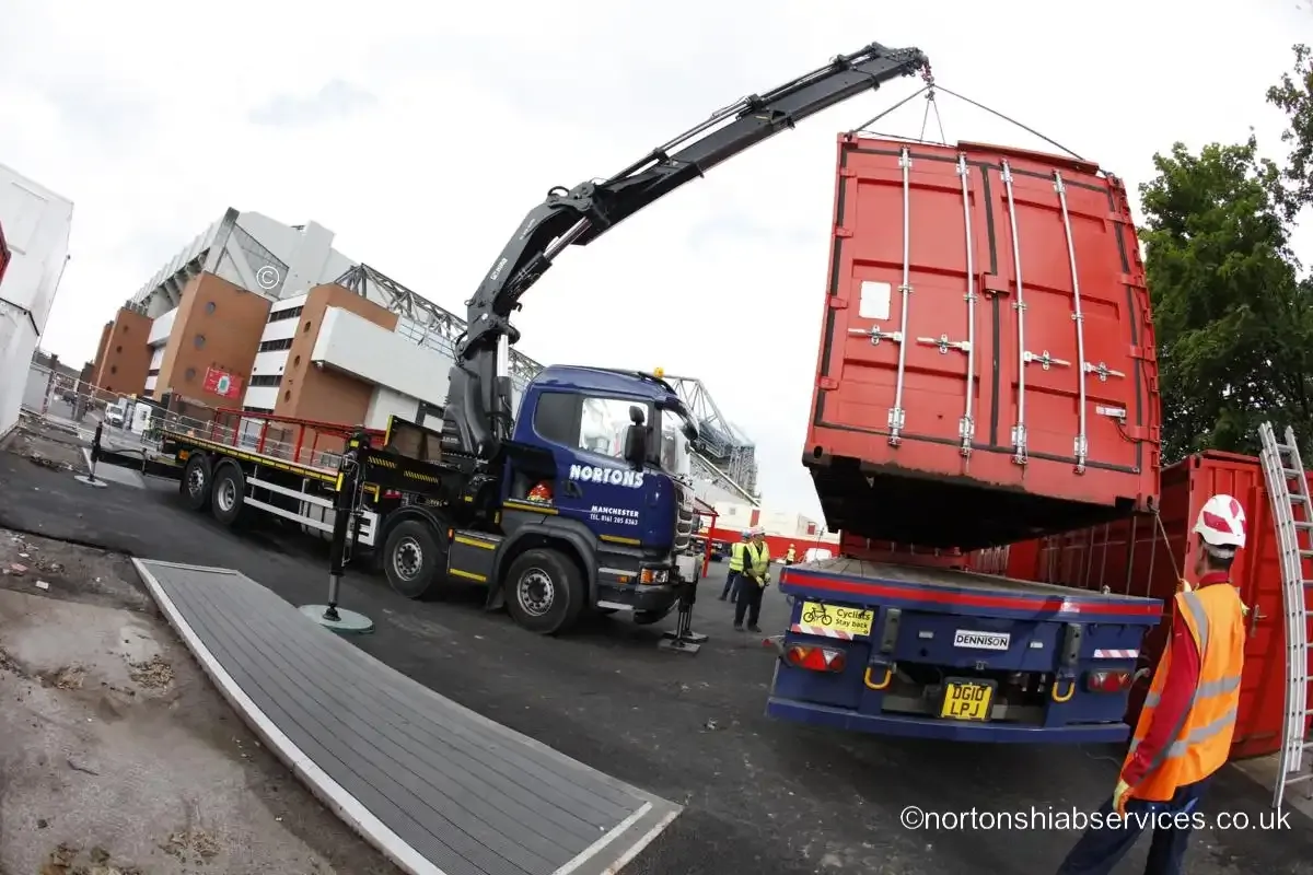 A Nortons hiab slewing a site unit into position at the Anfield stadium works