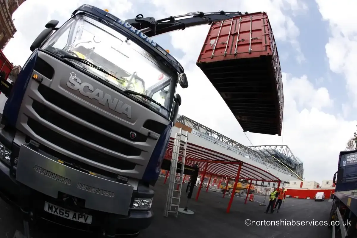 A Nortons hiab boom extended with a site unit suspended away from the vehicle