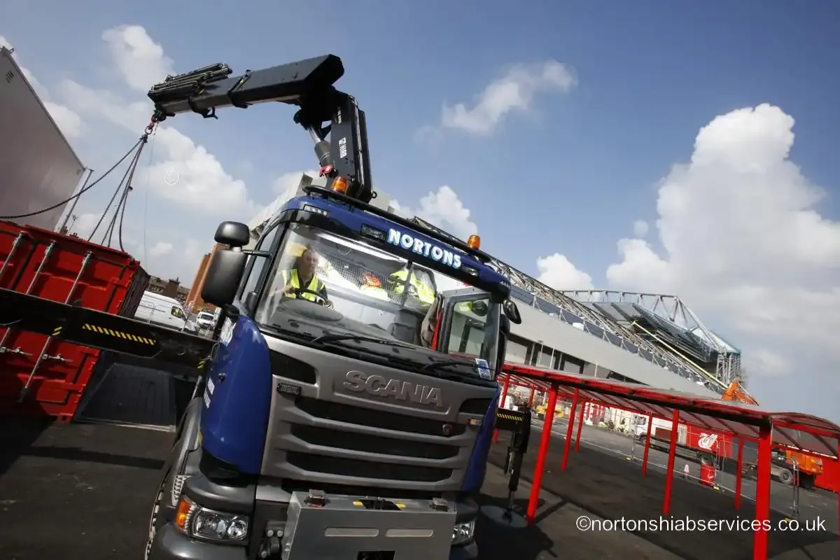 A site unit craned over the hoarding line into the Anfield construction site