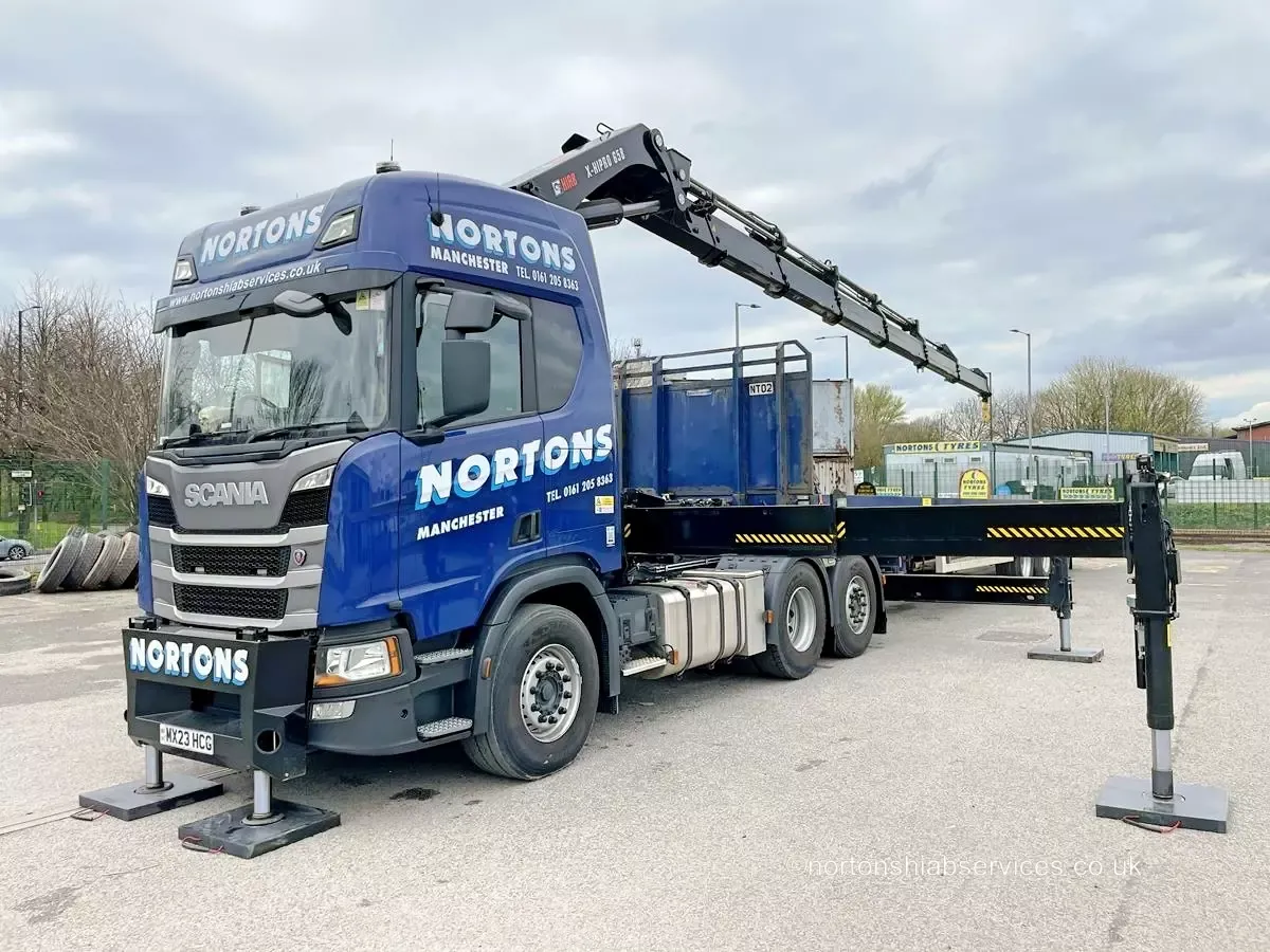 Nortons artic lorry loader on its stabiliser legs with the crane folded behind the cab