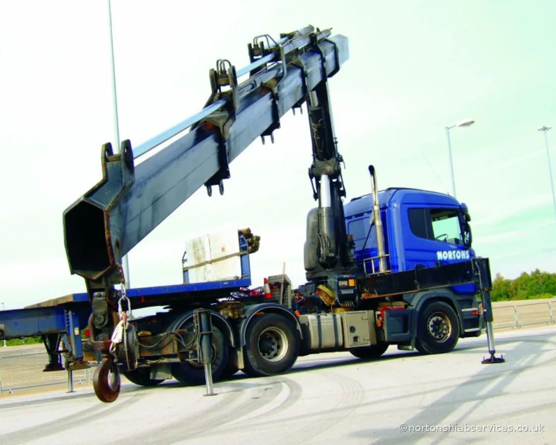 Close view of a Nortons loader crane boom folded over the cab