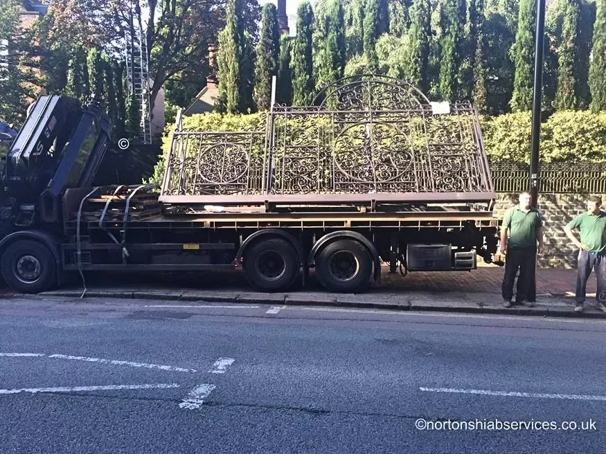 Nortons lorry loaded with long gate sections on a road