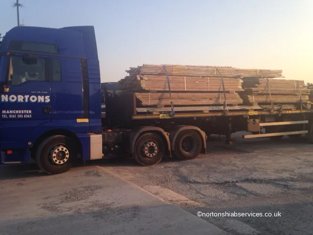 Nortons flatbed lorry loaded with banded scaffold boards