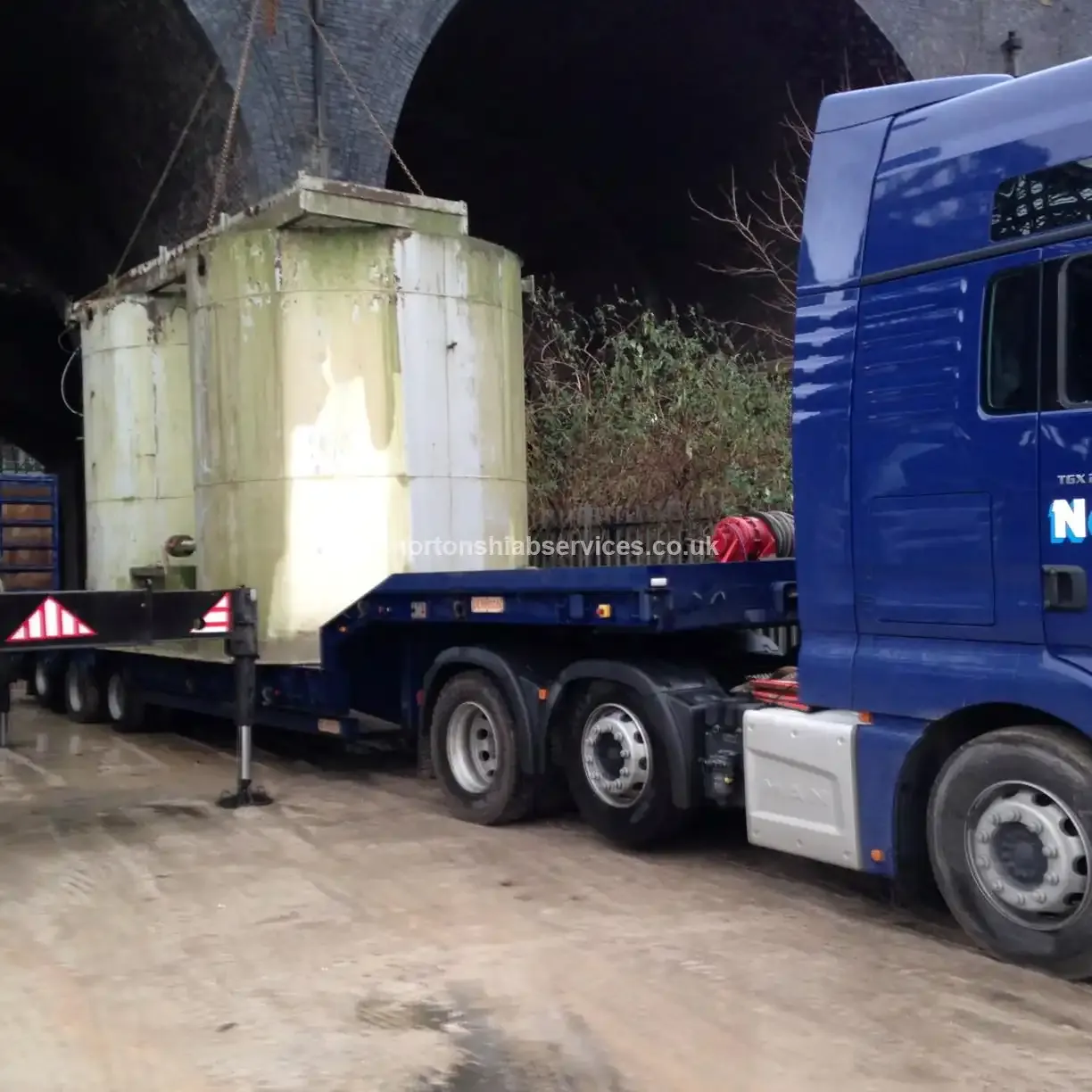 Nortons low loader carrying a cement hopper in transit