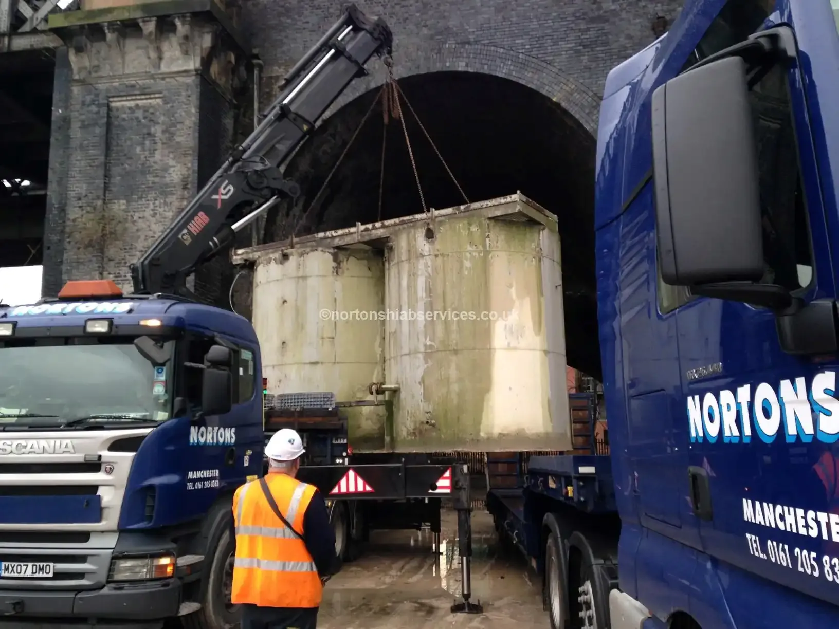 Cement hopper chained down on the deck of a Nortons low loader