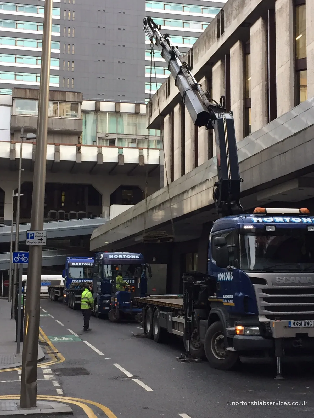 Nortons hiab with outriggers set on a Manchester city-centre footway