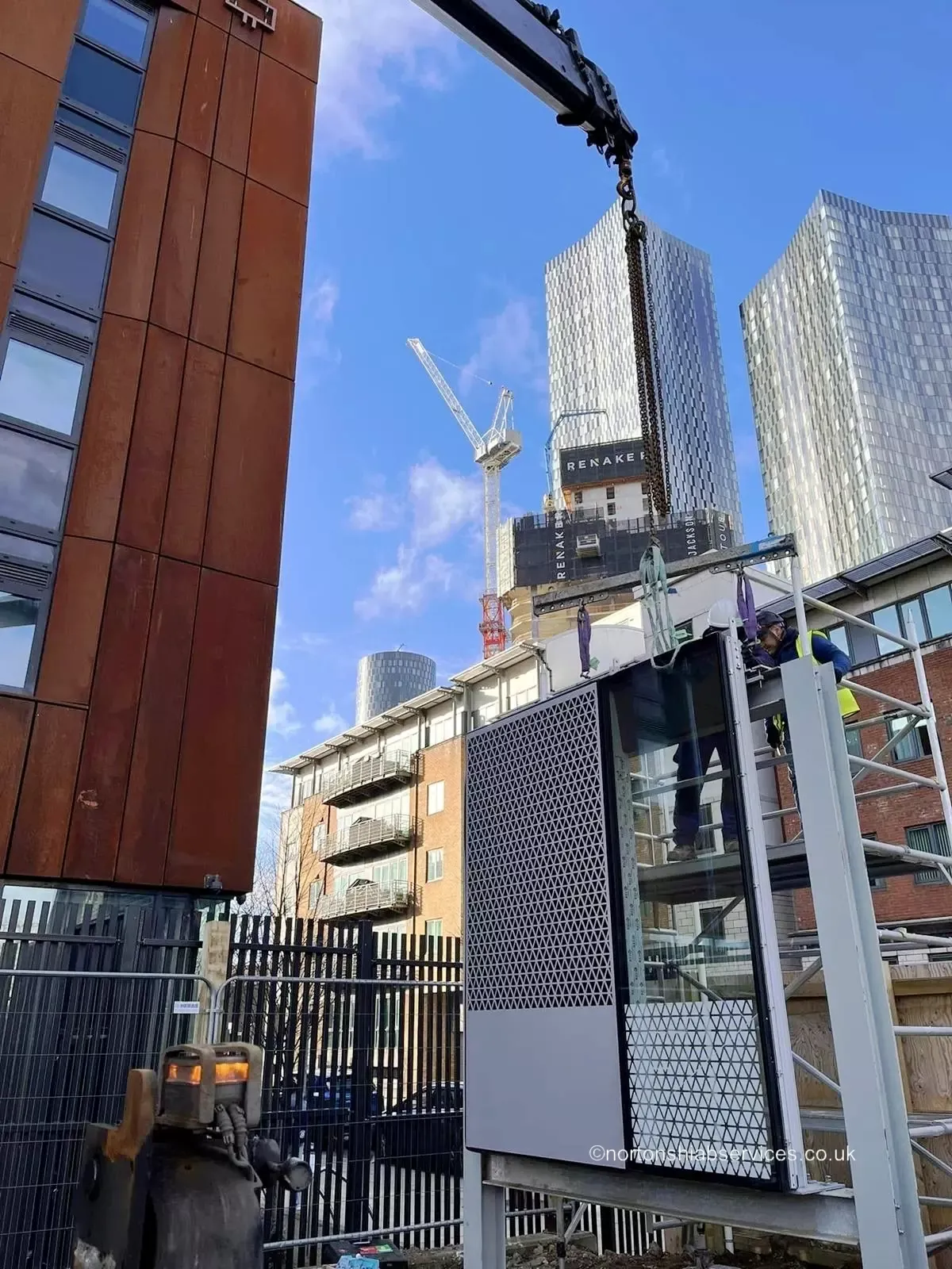 Nortons hiab lifting cladding panels onto a Manchester city-centre building