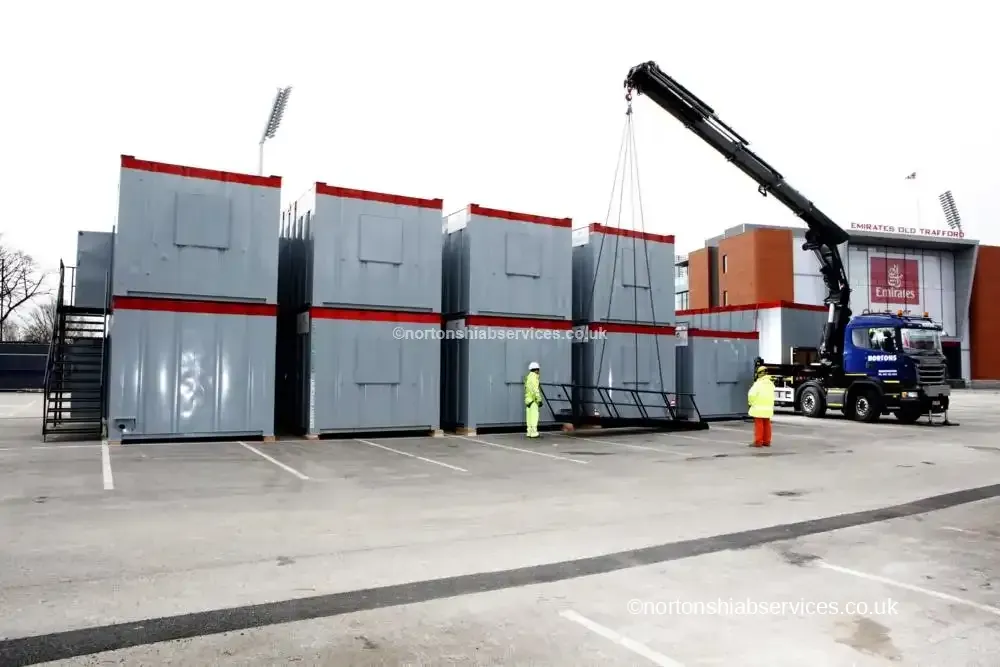 A Nortons hiab lifting a unit at a cricket ground in Manchester