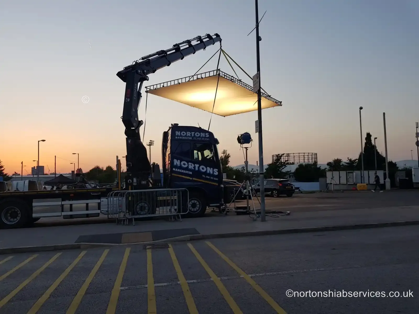 Nortons hiab holding a lighting rig for a film unit in Manchester