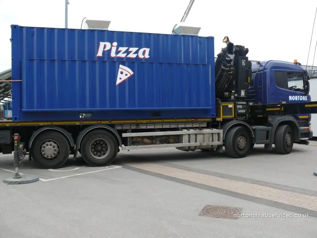 A Nortons hiab loaded with a prefabricated catering kiosk on the concourse at the Etihad Stadium, Manchester