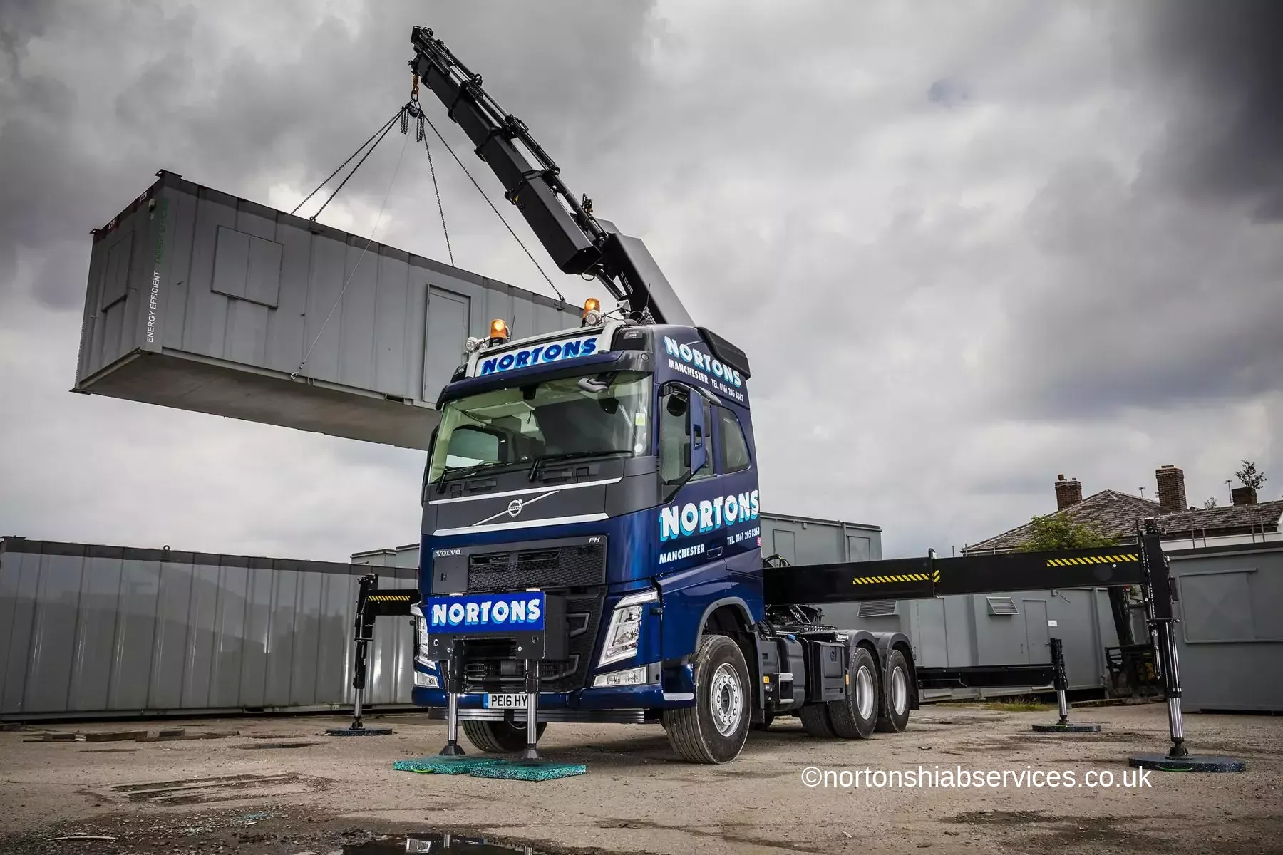 Nortons Volvo hiab lifting a large clad panel on a Manchester site