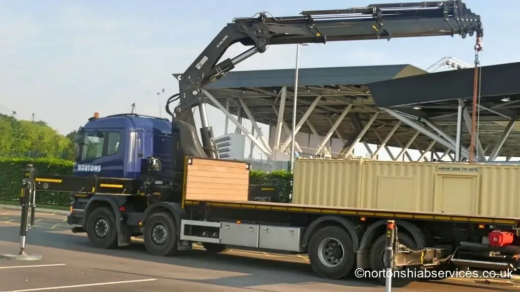Nortons hiab with the crane extended over the boundary at the academy site