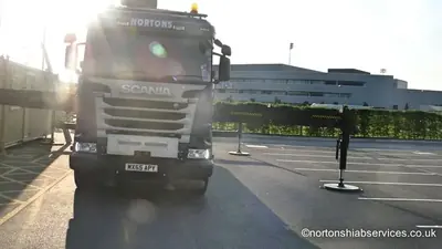 Nortons Scania hiab arriving at the Manchester City Academy development in early sunlight