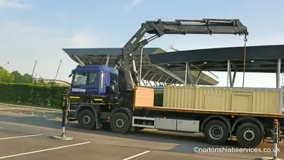 Cabin loaded on the deck of a Nortons hiab with the crane stowed