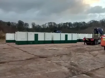The finished run of green and white welfare cabins across the compound at Caernarfon