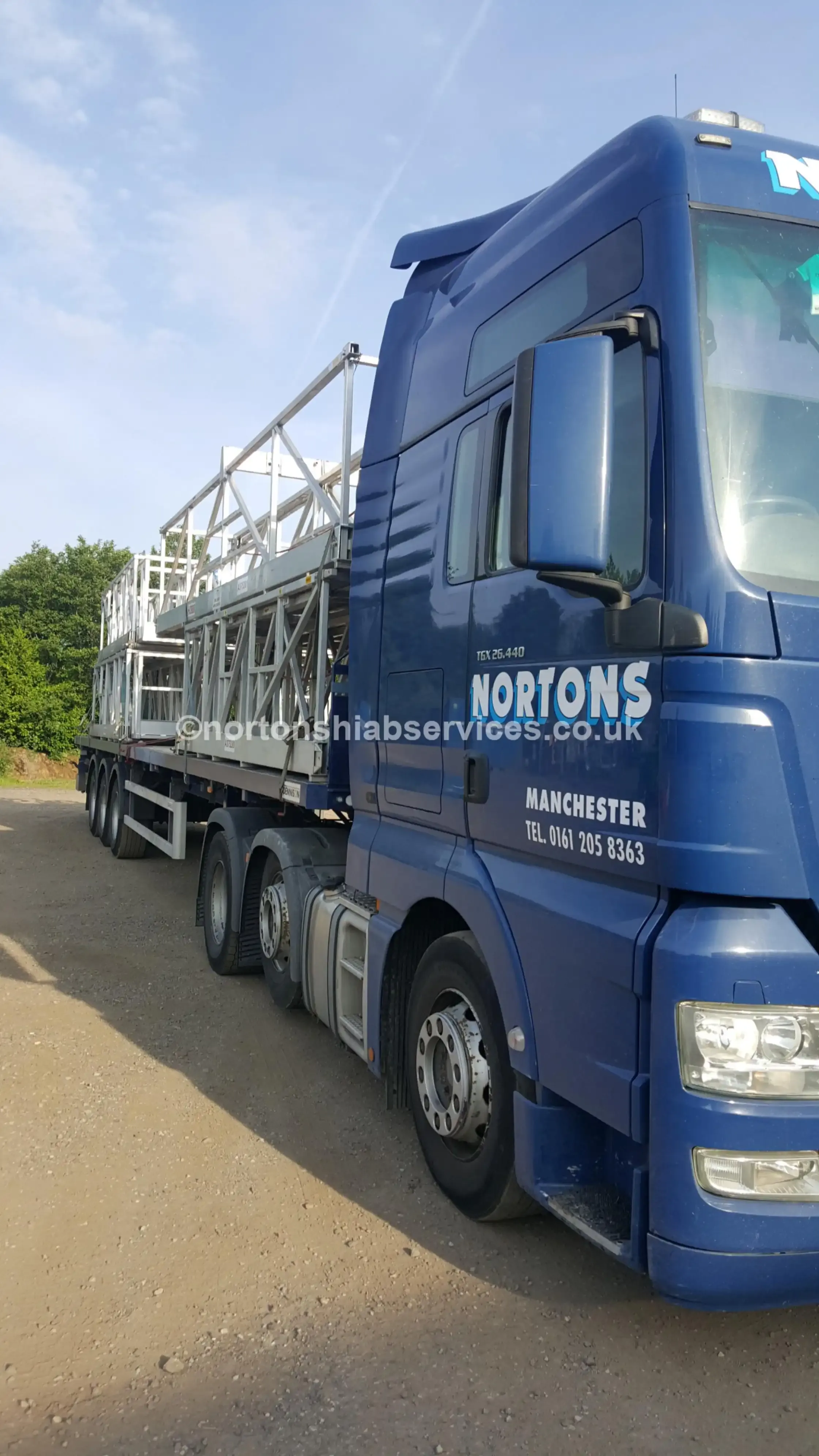A Nortons artic loaded with a long aluminium access platform structure on an extendable trailer