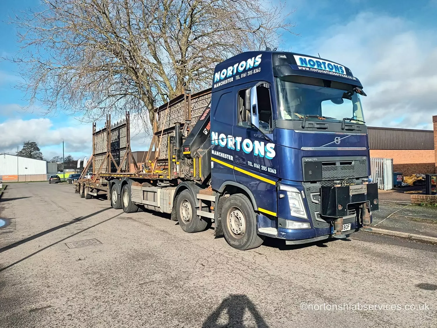 A Nortons wagon and drag outfit loaded with metal gates and fencing panels