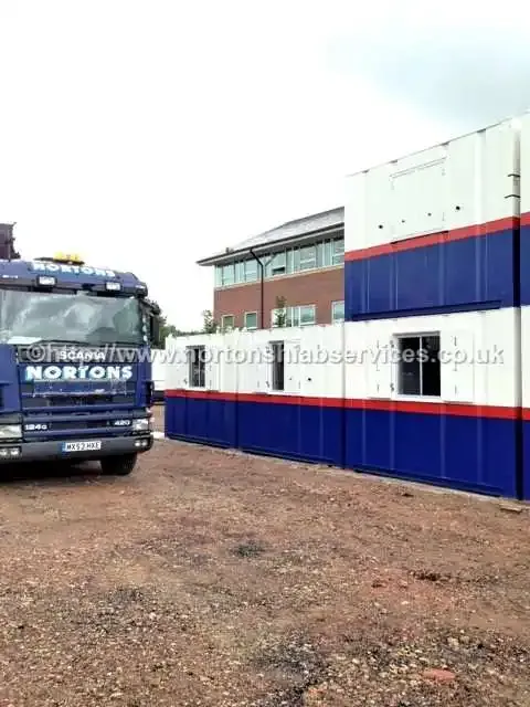 Nortons hiab lifting a steel frame inside a Lancashire site compound