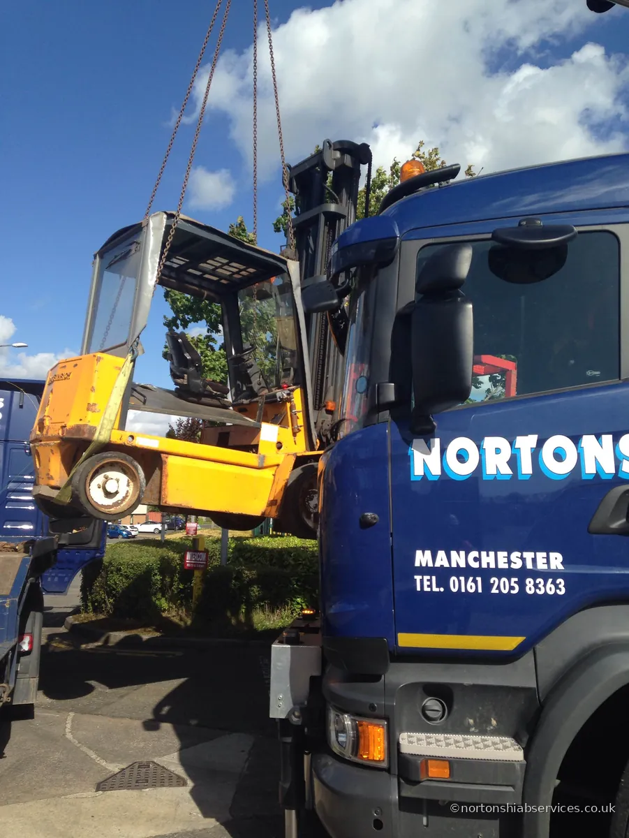 A forklift being positioned on a Nortons flatbed at Risley