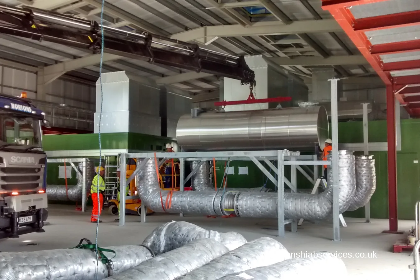 A Nortons hiab lifting insulated ductwork inside a renewable energy plant at Dukinfield
